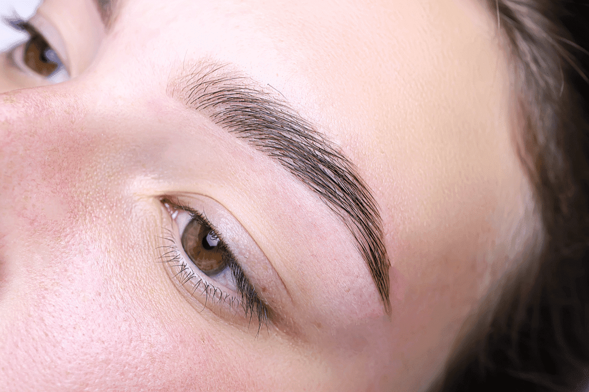Close-up of a person's eye and eyebrow detailing makeup accuracy.